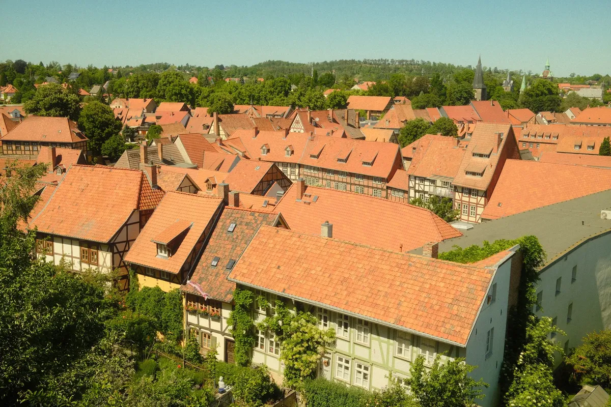 Aerial view of historic red-roofed buildings in Quedlinburg, Germany, showcasing traditional architecture.