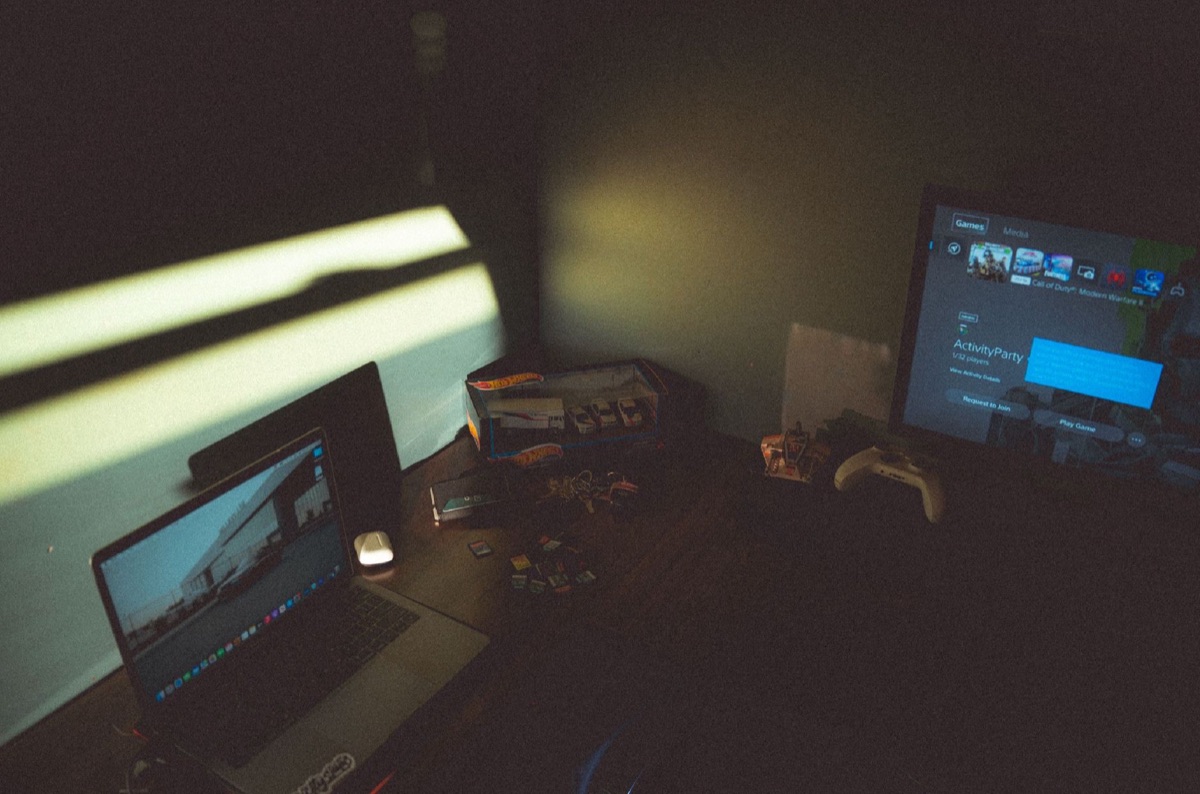 German gaming laptop setup in a dark room