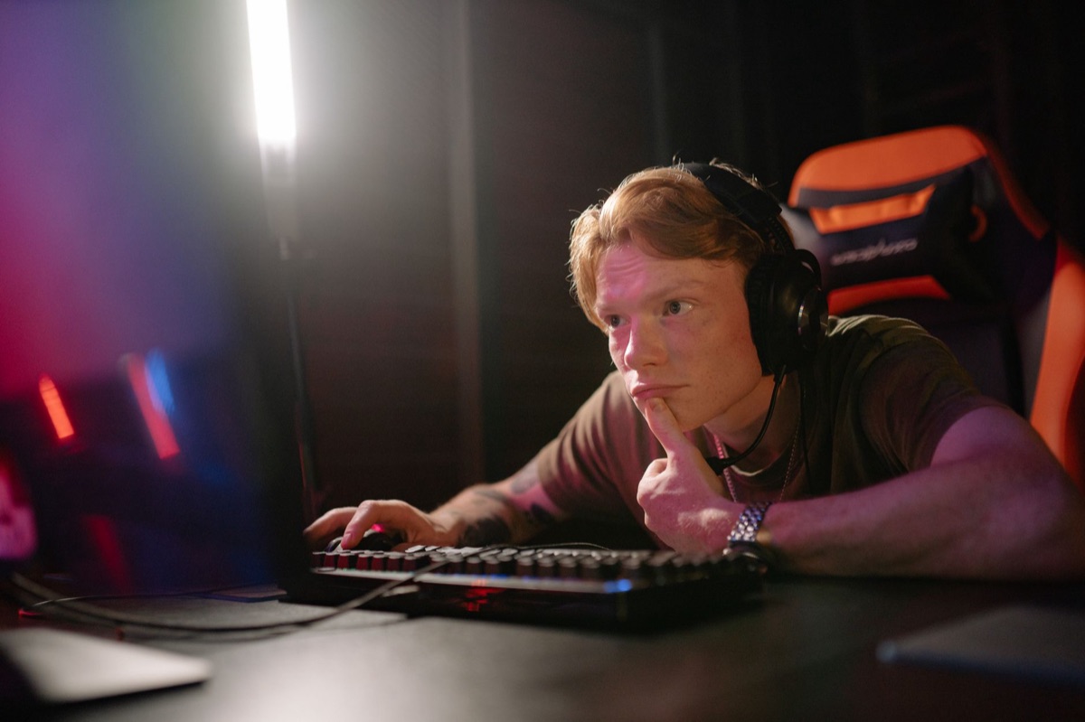 YouTuber in gaming room with monitors