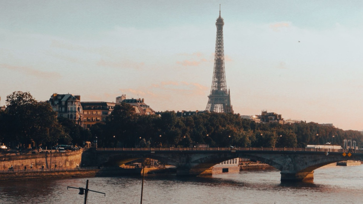 Tourist taking photo of Eiffel Tower at sunset